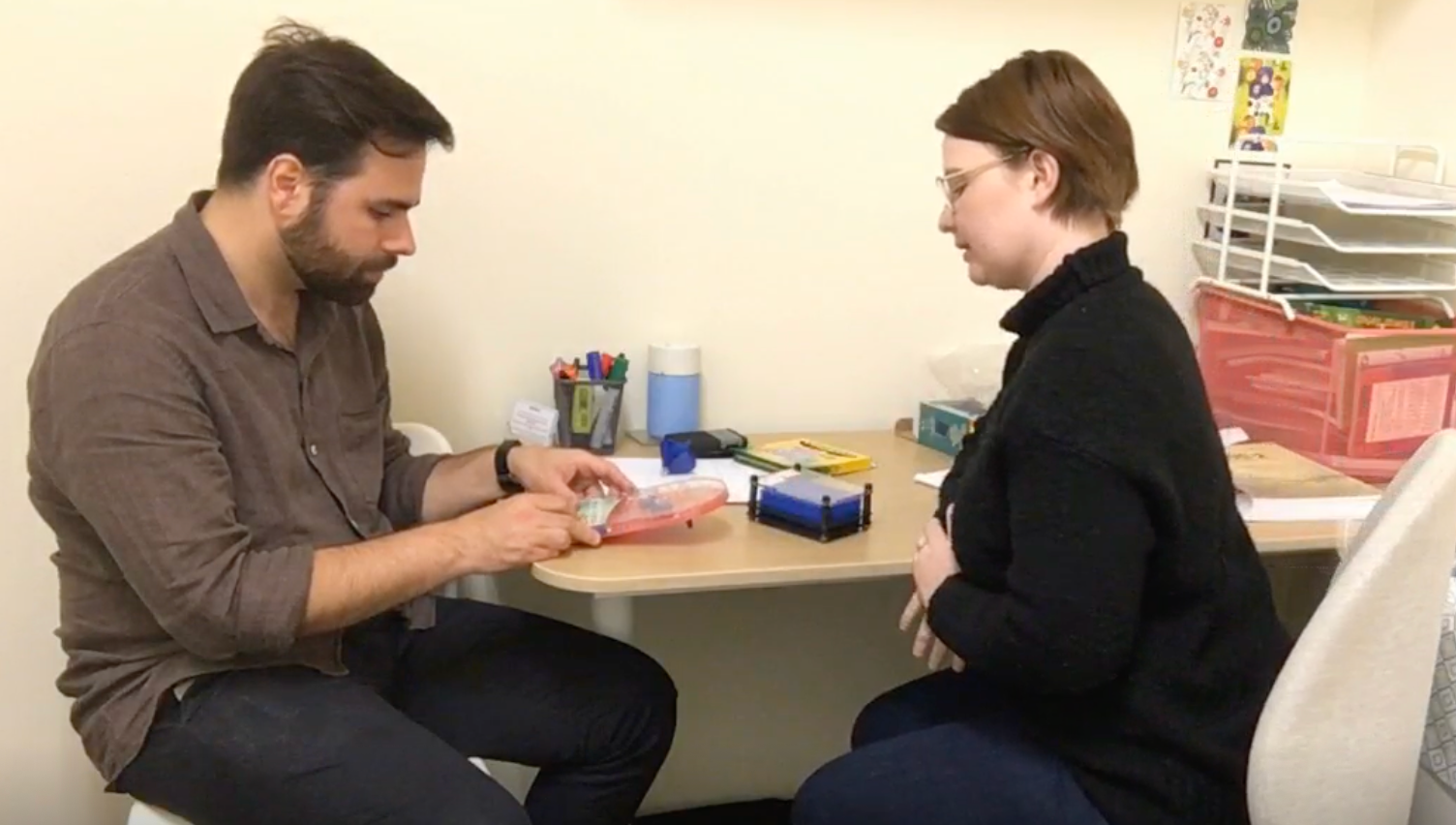 Psychologist conducting a hands-on assessment activity