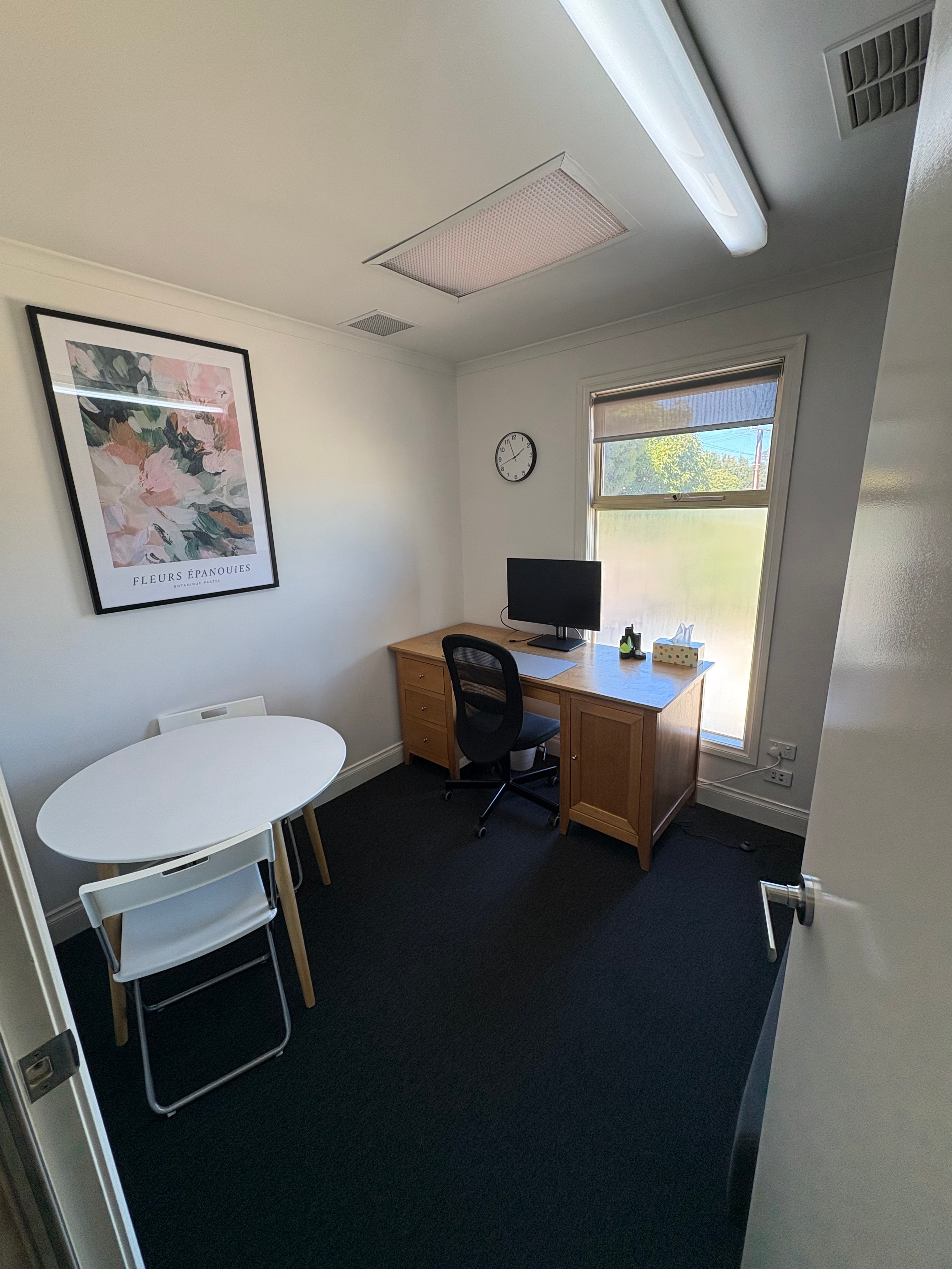 Payneham consulting room with desk and round table